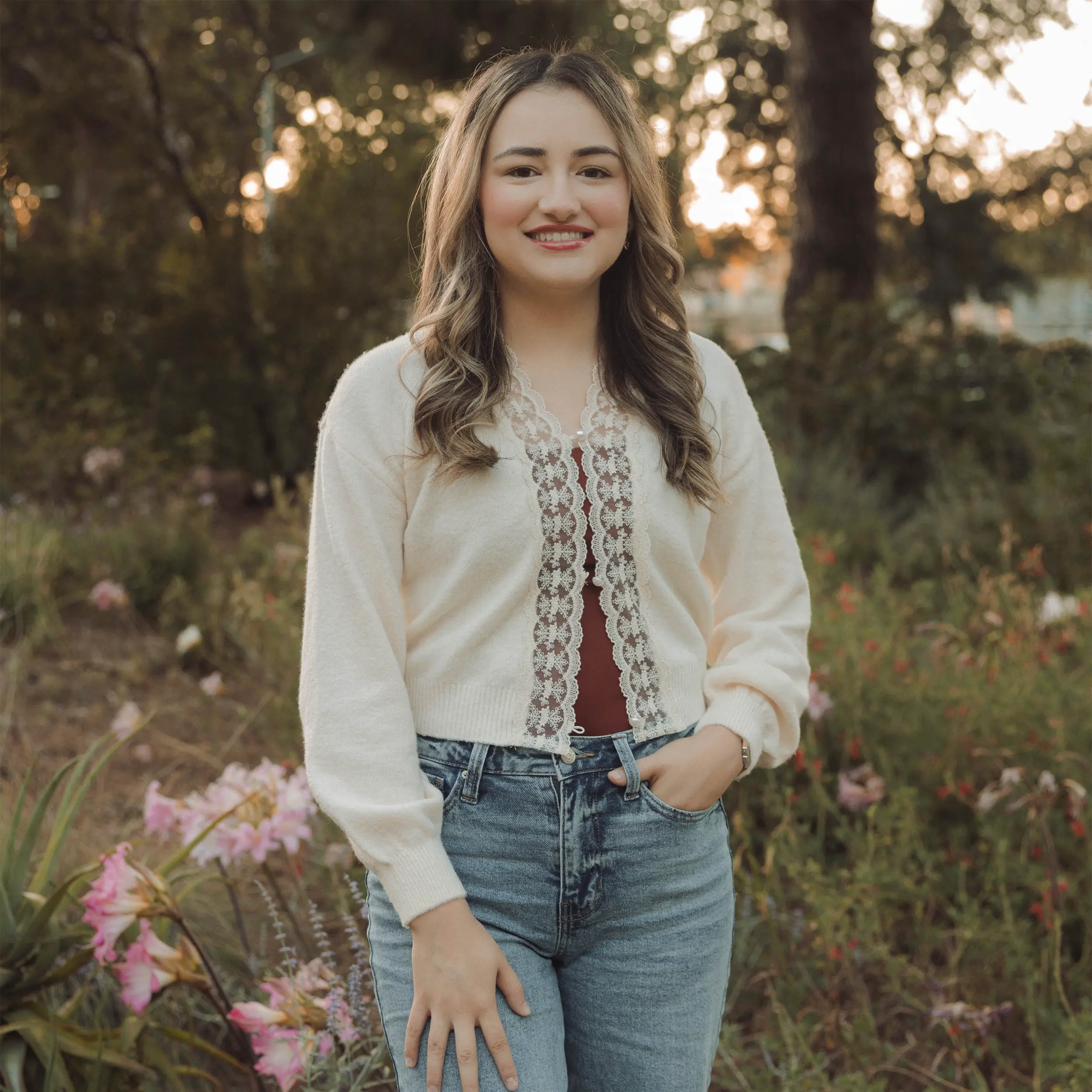 Julissa Chavana, graduate student in the Velazquez Lab at UC Davis, smiling outdoors in a garden setting